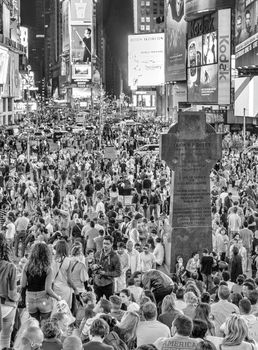 NEW YORK CITY - JUNE 11, 2013: Tourists crowded in Duffy Square at night, famous tourist attraction.