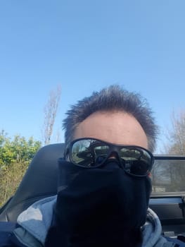 Shot of a serious looking man wearing a mask and sunglasses on infectious diseases
