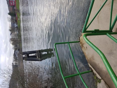 Flood on the river with a dock made of concrete