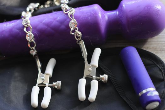 BDSM themed images showing a large dildo, nipple clamps, restraints, eye covers, and a condom. High quality photo