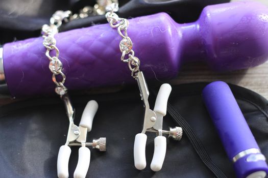 BDSM themed images showing a large dildo, nipple clamps, restraints, eye covers, and a condom. High quality photo