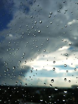 Raindrops on glass. Rainy weather. sad day. Dark sky.