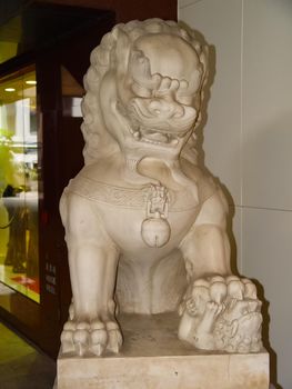 A stone lion at the door of the entrance to the building. A symbol of lion protection.