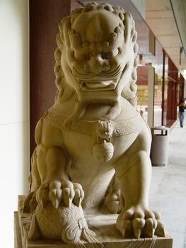 A stone lion at the door of the entrance to the building. A symbol of lion protection.