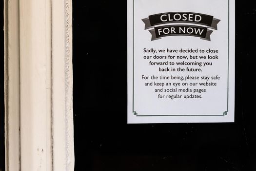 Closed for now sign on a restaurant window during lockdown caused by covid-19 pandemic