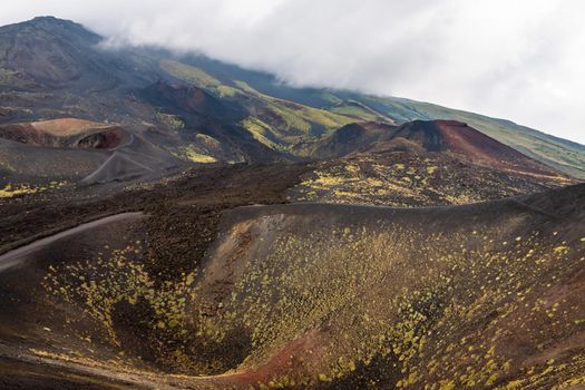 View of Etna volcano craters among the clouds near Rifugio Sapienza. Sicily, Italy