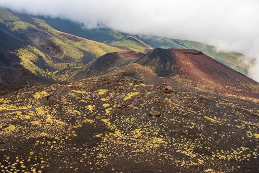 View of Etna volcano craters among the clouds near Rifugio Sapienza. Sicily, Italy