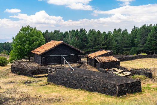 Summer view of Carpinteri refuge on Mount Etna built with lava stones, Sicily. Italy