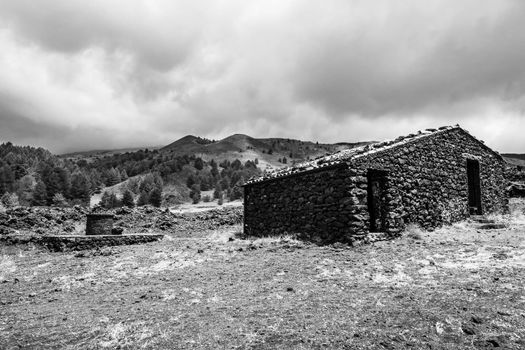 Santa Barbara refuge on Mount Etna built with lava stones, including the water well