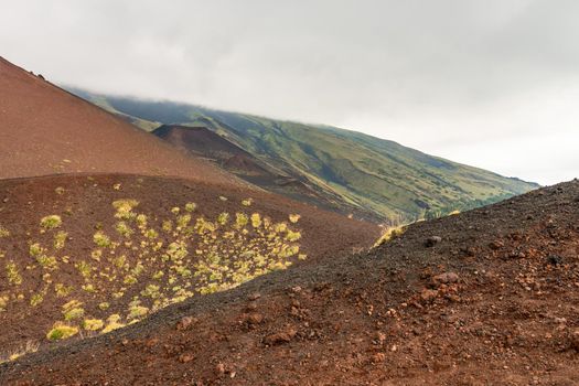 View of Etna volcano craters among the clouds near Rifugio Sapienza. Sicily, Italy