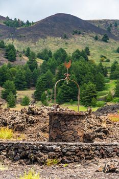 Santa Barbara refuge on Mount Etna built with lava stones, including the water well