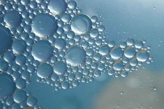 abstract macro background of oil circles floating over water surface . Macro closeup view of bubbles on water . oil bubbles in the water macro photographic background