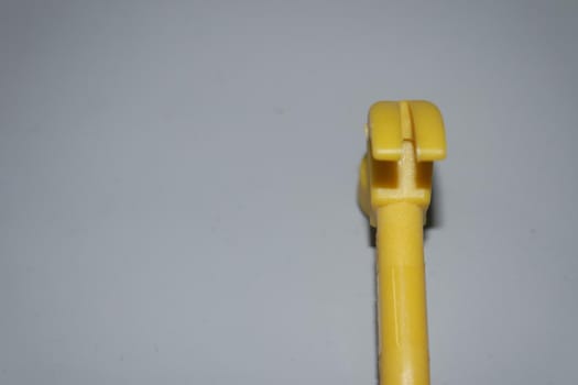 Selective focused, closeup view of toy hammer made from plastic placed on metal background