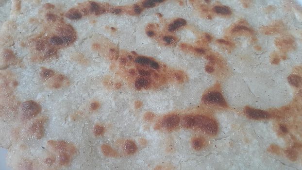 Closeup view of of traditional bread called Jawar roti or bhakri. Bhakri is a round flat unleavened bread often used in the cuisine of many Asian countries