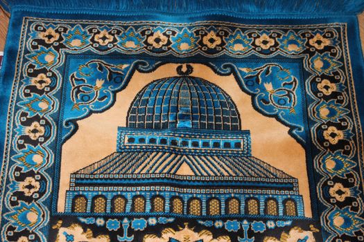 Closeup view of prayer rug in place to make prayer. High angle view of lovely prayer mat or prayer rug for Muslims