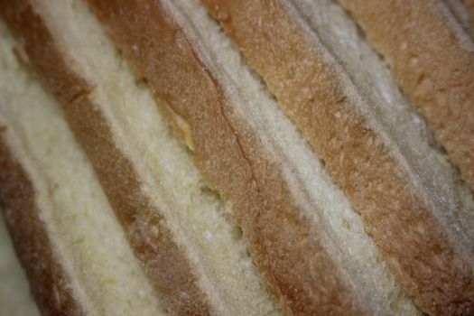 Closeup top view of freshly prepared slices of toast bread. Food background for bakery products