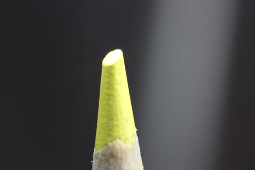 close up of sharpened pencil.Macro view of the tip of the pencil on a black background.