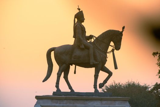 Jaipur, Rajasthan, India - circa 2020 : Madho singh statue with horse shot at dusk near albert hall in jaipur a landmark in the city and an often visited spot. Jaipur is a popular tourist spot and fast growing commercial hub near the capital of the country