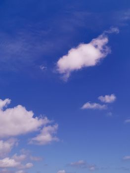 Vertical shot of a blue cloudy sky on a sunny day - great for wallpapers