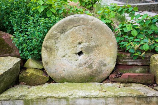 Closeup shot of an old millstone outside