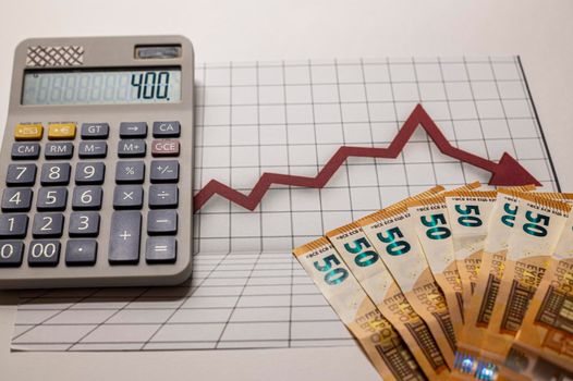 50 euro banknotes with graphs and calculator on white background