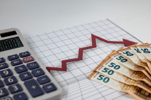50 euro banknotes with graphs and calculator on white background