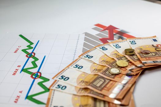 50 euro banknotes coins and statistics on white background