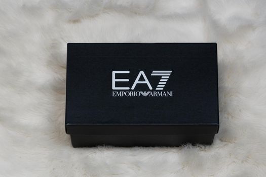 Display of order package containing a pair of Italian designers shoes with company logo.