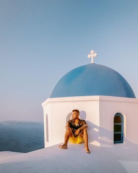 Santorini Greece, guy on vacation in Greece, young men on a luxury holiday at the island of Oia Greece Europe