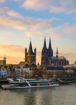 Cologne Germany November 2020, alongside the rhein river during sunset with the huge Cathedral in Koln