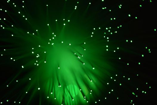 A green abstract background from a series of color changing images of the same scene of fiber optic cables.
