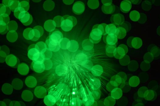 A green abstract background from a series of color changing images of the same scene of fiber optic cables.