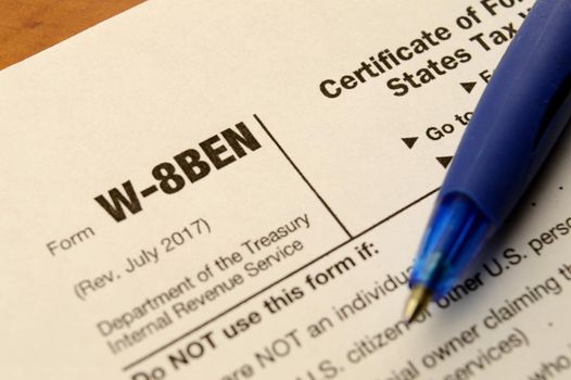 A macro shot of a blank W-8BEN form to fill out for selling copyrighted material in the USA and reduce any taxes held.