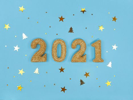 Greeting card of New Year 2021. Golden glittered figures and confetti on a blue background.