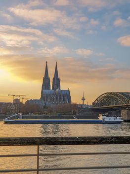Cologne Germany November 2020, alongside the rhein river during sunset with the huge Cathedral in Koln