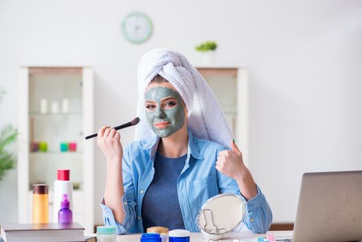 Beauty blogger applying mask and posting to internet blog