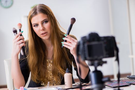 Beauty blogger filing video for her blog or vlog