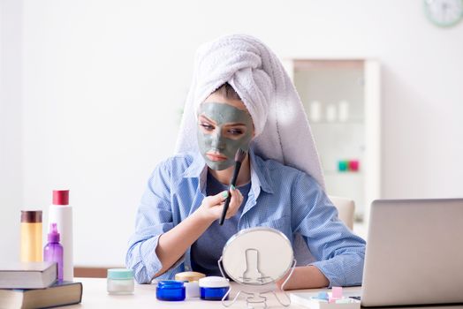 Beauty blogger applying mask and posting to internet blog