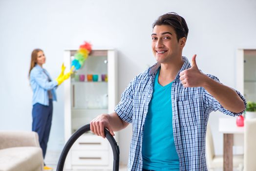 Young family cleaning the house