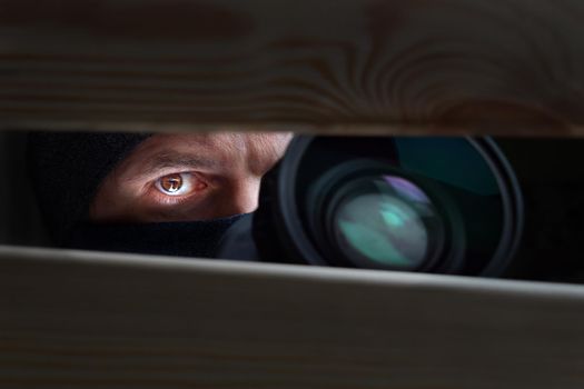 Spy Man. Peeping. Spying. Surveillance. Secret Information. Hidden Camera. Man hiding. Paparazzi. Stalker. Private Detective. Spy Camera. Spy Detective. Espionage. Privacy. Information. Investigation