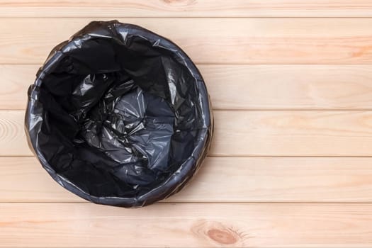 Trash Can Top View. Empty Garbage Bin. Black Bag in a Trash Can. Rubbish Bin. Bin on Wooden Floor. Waste Bin on Wooden Background. Waste Can with Plastic Package. Empty Rubbish Bucket. Garbage Basket