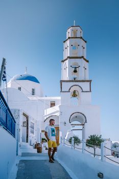 Santorini Greece, guy on vacation in Greece, young men on a luxury holiday at the island of Oia Greece Europe