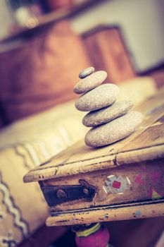 Feng Shui: Stone cairn in the foreground, blurry living room in the background. Balance and relaxation.