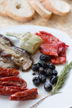 Italian antipasti as dinner appetizer. Tomatoes, Olives, paprika and more.