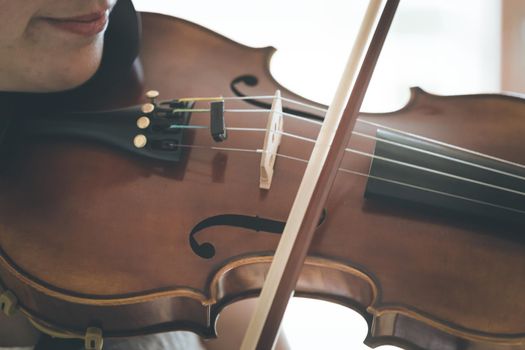 Pretty young girl practices on her violin, acoustic music