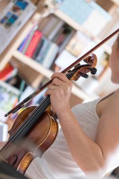 Pretty young girl practices on her violin, acoustic music