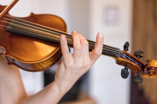 Pretty young girl practices on her violin, acoustic music