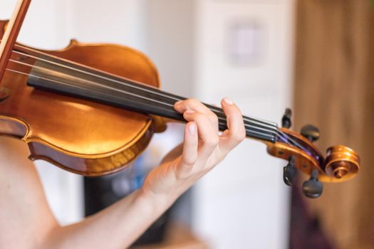 Pretty young girl practices on her violin, acoustic music