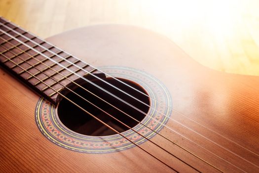 Cutout of a classical guitar corpus and strings, closeup