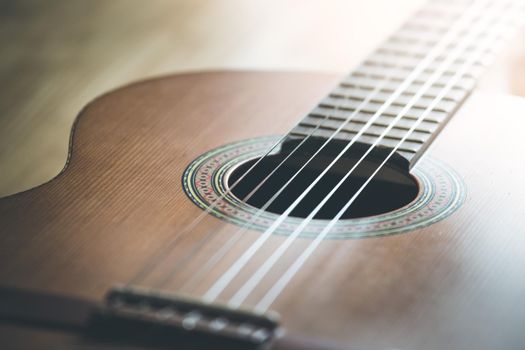 Cutout of a classical guitar corpus and strings, closeup